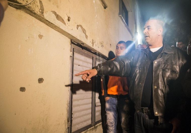 People gather at the site where Israeli special forces shot dead Nashat Milhem