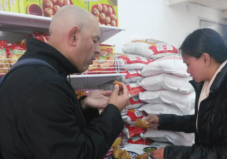 MAJUMDAR AND his wife, Sybil, sample samosas in Jerusalem.
