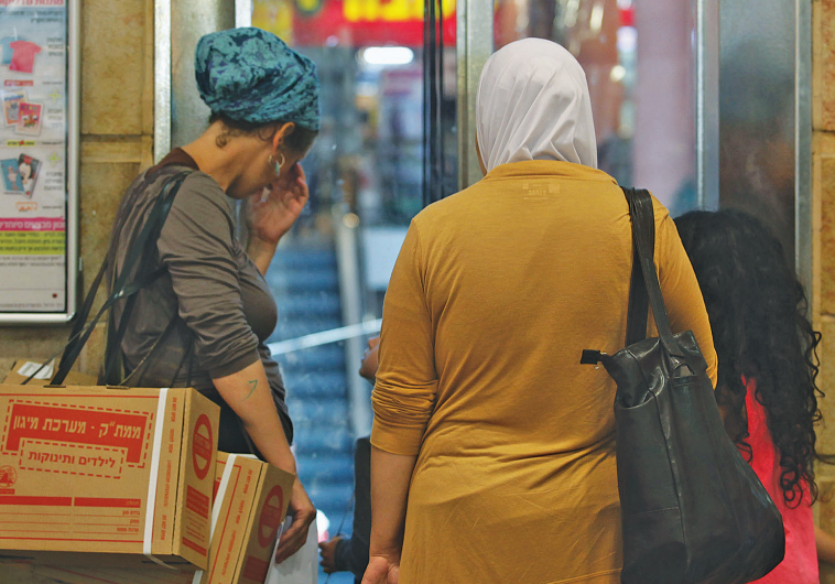 JEWISH AND ARAB Israelis wait outside a distribution center to trade in their First Gulf Warera prot