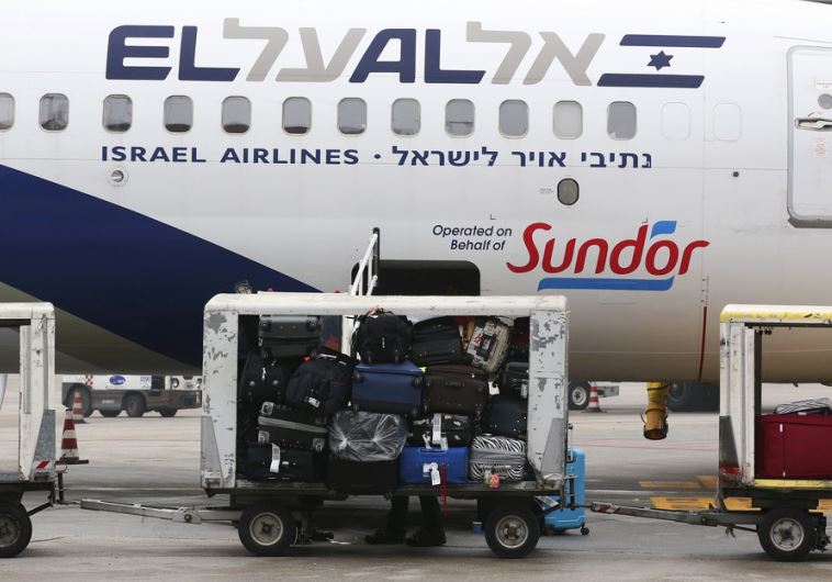 Baggage carts are seen on the tarmac near an El Al Israel Airlines plane at Venice airport