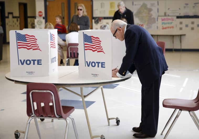 A voter fills out his ballot at Sleepy Hollow Elementary School in Falls Church, Virginia.
