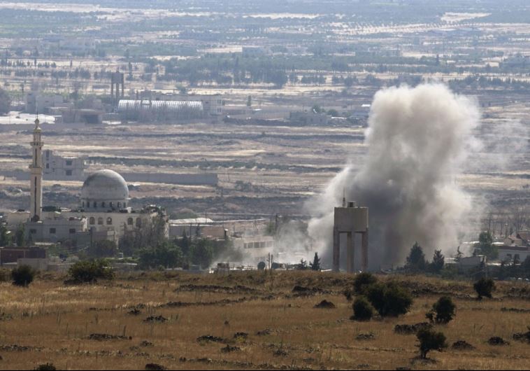 Smoke rises during fighting in the village of Ahmadiyah in Syria
