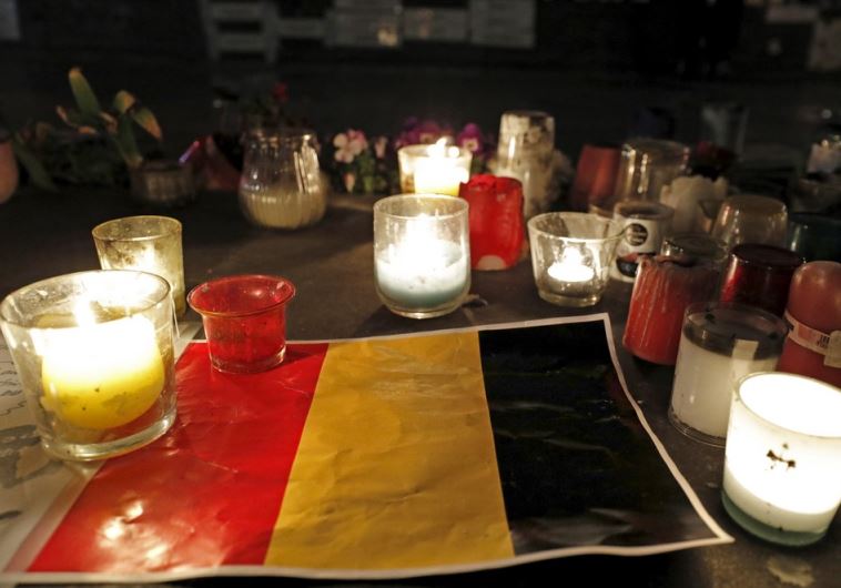 Candles are pictured around a Belgian flag on the Place de la Republique in Paris