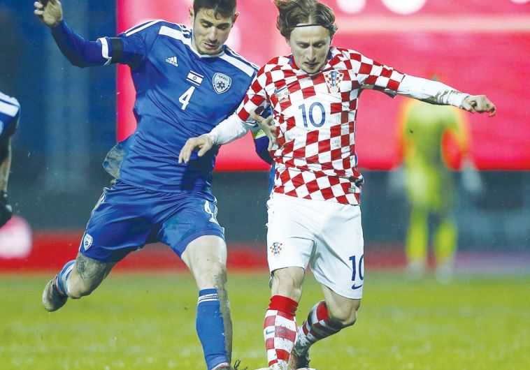 Israel midfielder Nir Biton (left) battles Croatia’s Luka Modric for the ball 