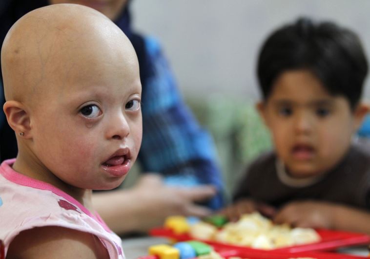 Students with Down's syndrome attend a special class in the Hibato Allah Center in Baghdad