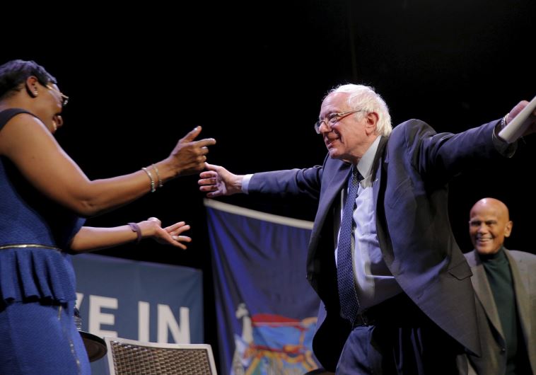 US Democratic presidential candidate and US Senator Bernie Sanders hugs former Ohio State Senator Ni