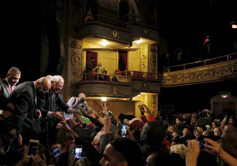 US Democratic presidential candidate and US Senator Bernie Sanders greets audience members at a camp