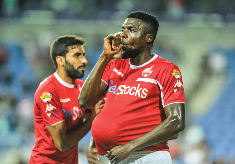 Hapoel Beersheba midfielder John Ogu, whose wife is expecting their first child, celebrates in appro