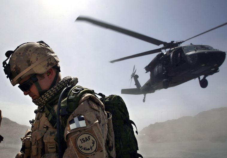 A Canadian soldier from the NATO-led coalition force turns his back away 