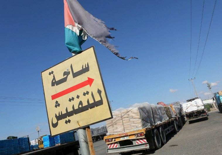 Trucks loaded with bags of cement enter the Gaza Strip from Israel through the Kerem Shalom crossing