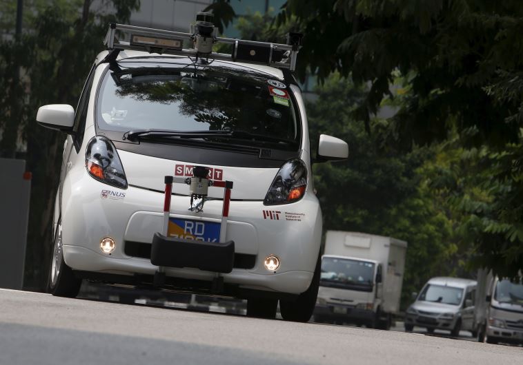 An autonomous self-driving vehicle goes onto the road during a demonstration at one-north business p