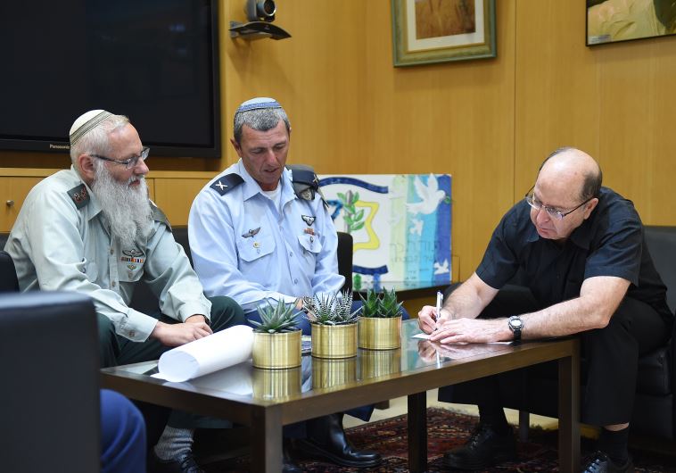 Rabbi Col. Eyal Karim (left), nominated to become IDF chief rabbi, sits next to his predecessor, Bri