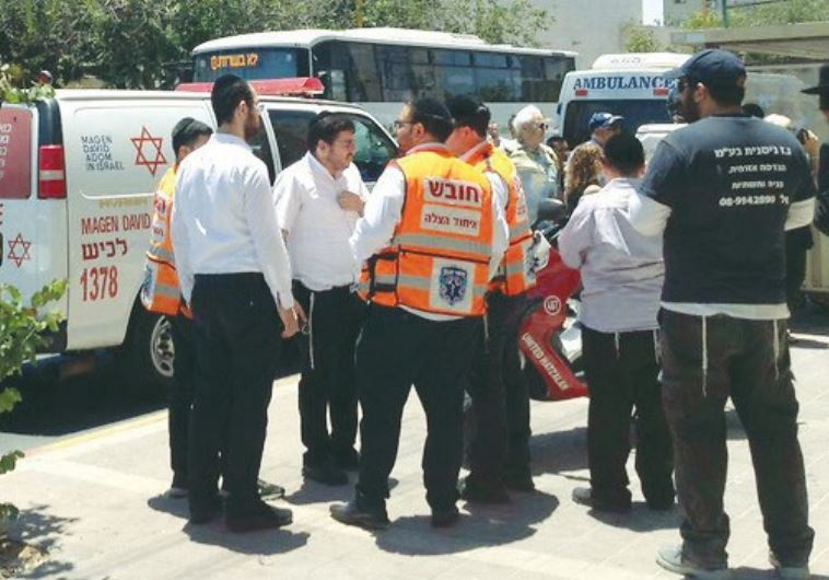 AMBULANCE STAFF in Ashdod attend the scene on May 30 where an infant left in a car died.