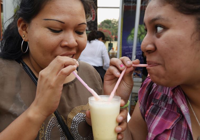 People drink traditional Peruvian Pisco Sour during a Pisco Sour festival in Lima