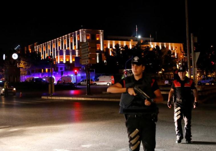 Police officers stand guard near the Turkish military headquarters in Ankara, Turke