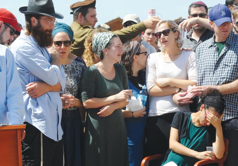 SGT. SHLOMO Rindenow’s family members mourn at his funeral yesterday at Netzer Hazani.