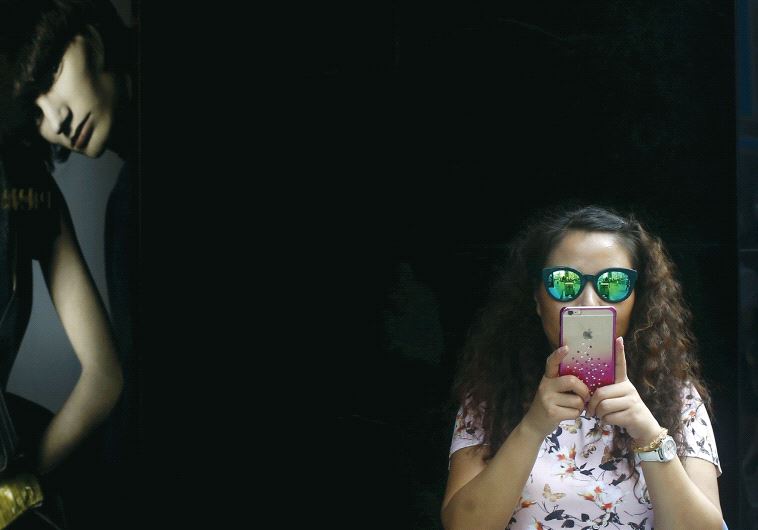 A girl holds a smartphone