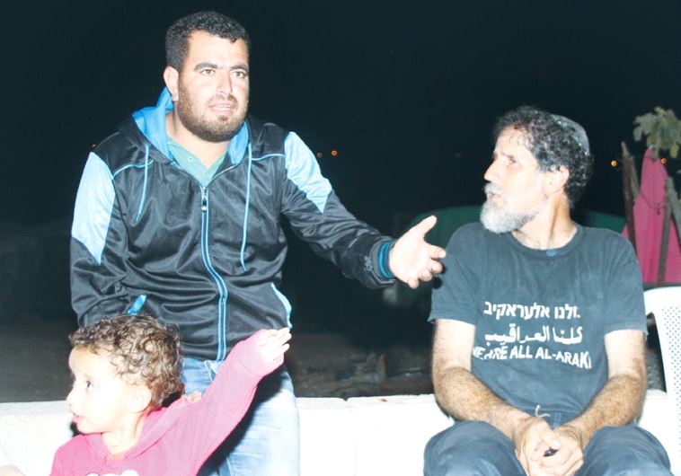 VILLAGER NASSER NAWAJAA makes a point to human rights activist Rabbi Arik Ascherman in Sussiya yeste