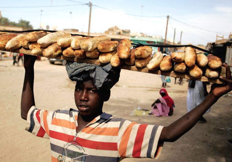 A BOY carries loaves of bread in a Nouakchott marketplace in 2009.