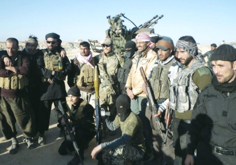AL-JUGHAYA tribal members pause for a group photo while fighting ISIS under siege.