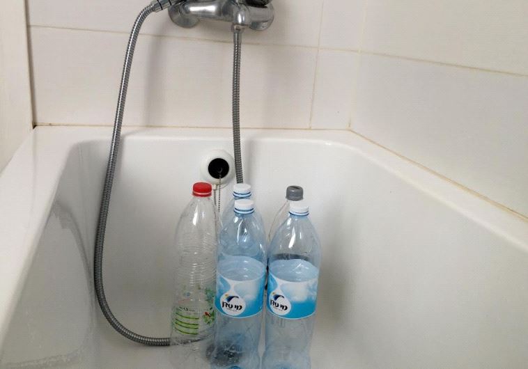 Rehovot residents filled up old bottles with water in preparation for water shut off. 