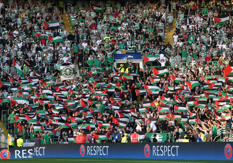 Celtic fans hold up Palestinian flags at EUFA Champions League Qualifying match versus Hapoel Beer-S