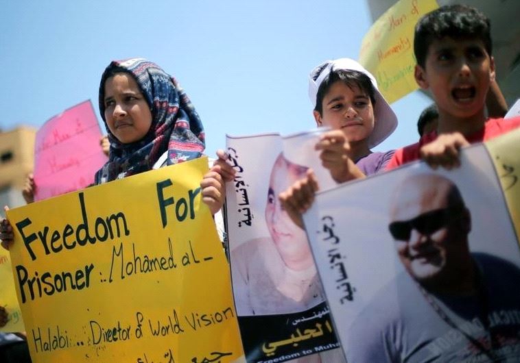 Palestinian demonstrators take part in a protest in solidarity with Mohammad El Halabi, World Vision