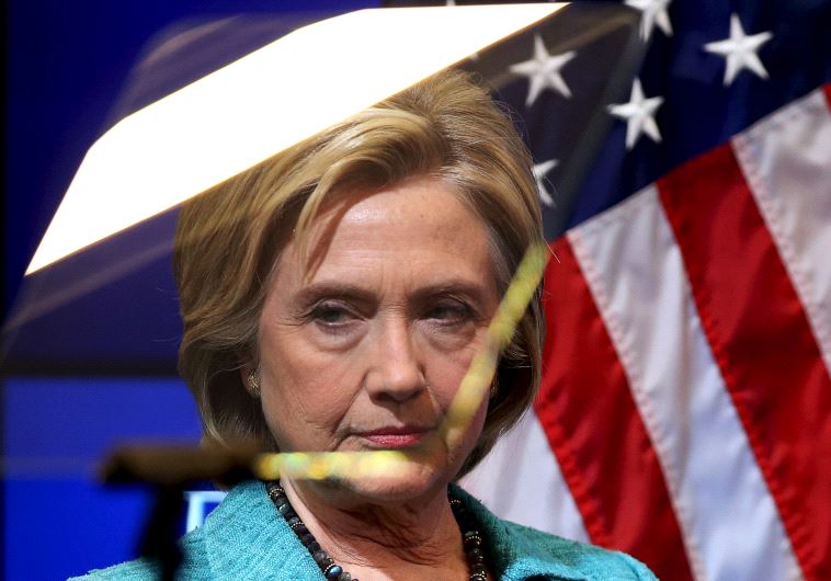 Democratic presidential candidate Hillary Clinton looks through a teleprompter before discussing the