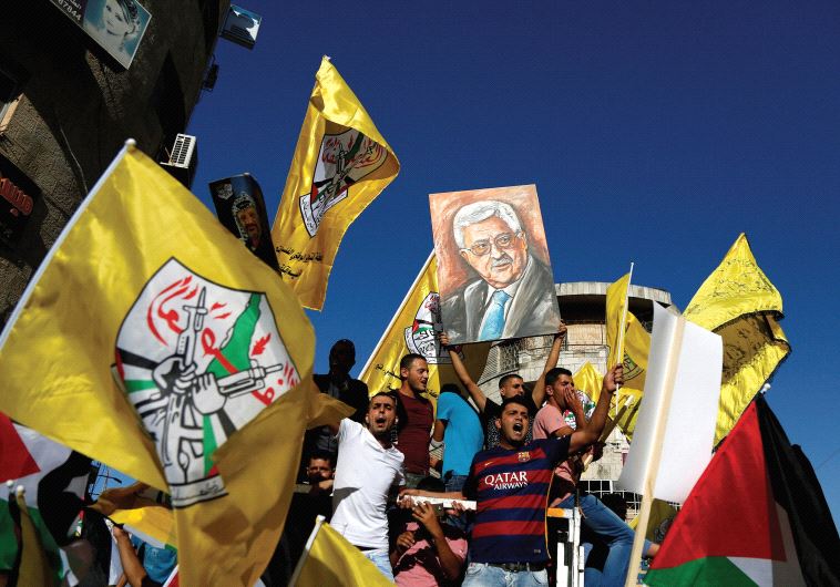 PALESTINIANS PARTICIPATE in a recent rally to support Palestinian President Mahmoud Abbas in Ramalla