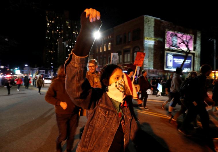 Demonstrators march as they shout slogans against President-elect Donald Trump in Minneapolis