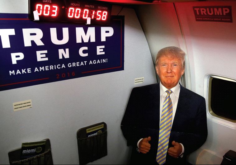 A CARDBOARD cutout of Donald Trump is pictured on a media charter plane with a countdown clock to th