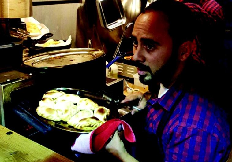  Argento chef Lucas Zitrinovich prepares an empanada 