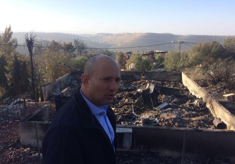 Education Minister Naftali Bennett surveys the fire