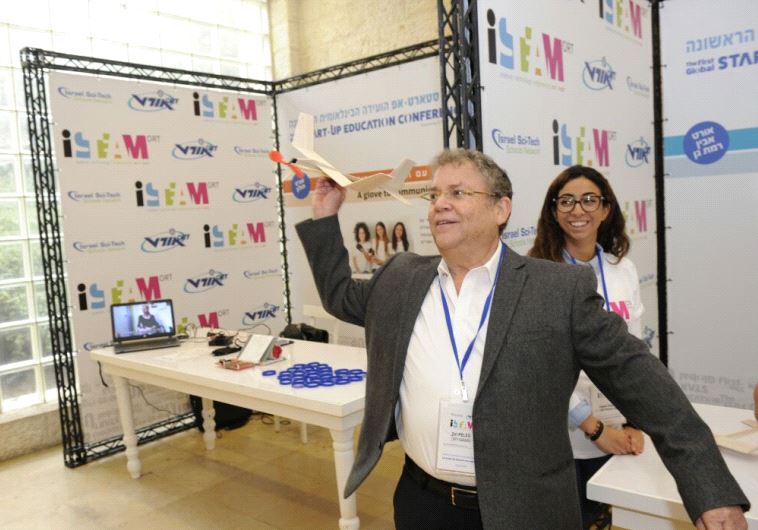 Zvi Peleg, director general of ORT Israel playing with ORT Ramat Gan's projects during the summit. 
