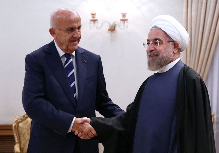 Iranian President Hassan Rouhani greeting Lebanese Defense Minister Samir Moqbel (L) at the presiden