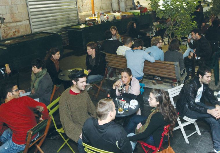 PEOPLE DRINK at Jerusalem’s Casino de Paris bar, something