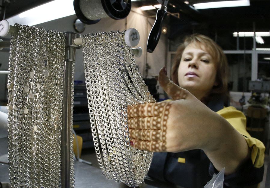 An employee takes silver chains at the jewelry departmen