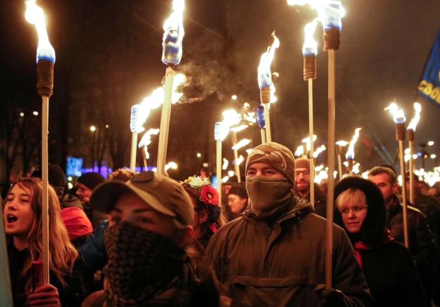 Activists of the Svoboda (Freedom) Ukrainian nationalist party hold torches as they take part in a r