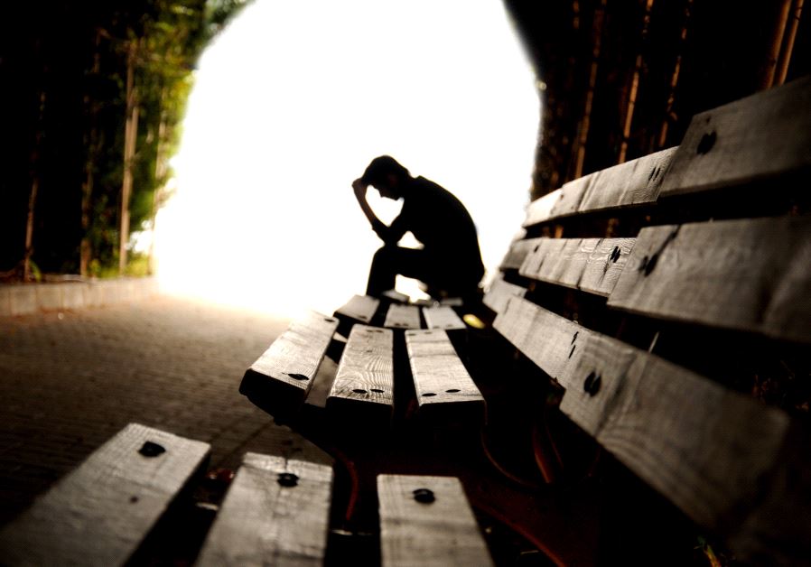 Depressed person broods in tunnel
