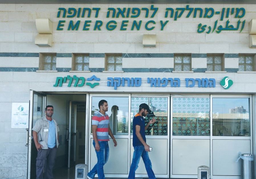 MEN EXIT the emergency room at Soroka University Medical Center in Beersheba.