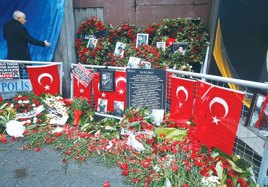 FLOWERS AND PICTURES of the victims of a terrorist attack are placed near the entrance to Istanbul’s