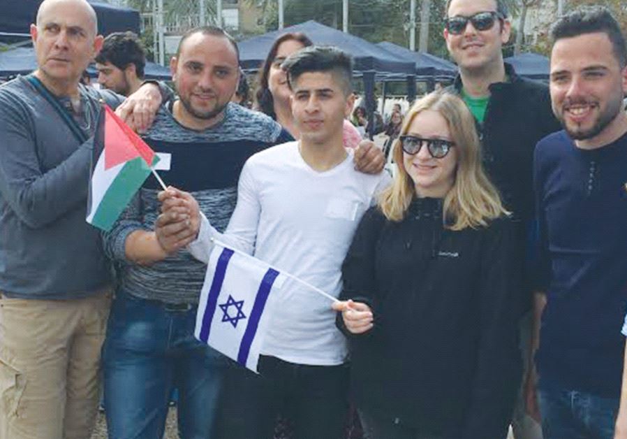 PEOPLE POSE for a photo at the Minds of Peace event in Tel Aviv on Friday.