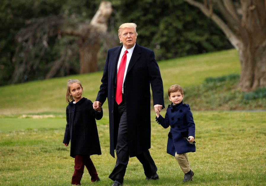 U.S. President Donald Trump holds hands with grandchildren Arabella and Joseph Kushner