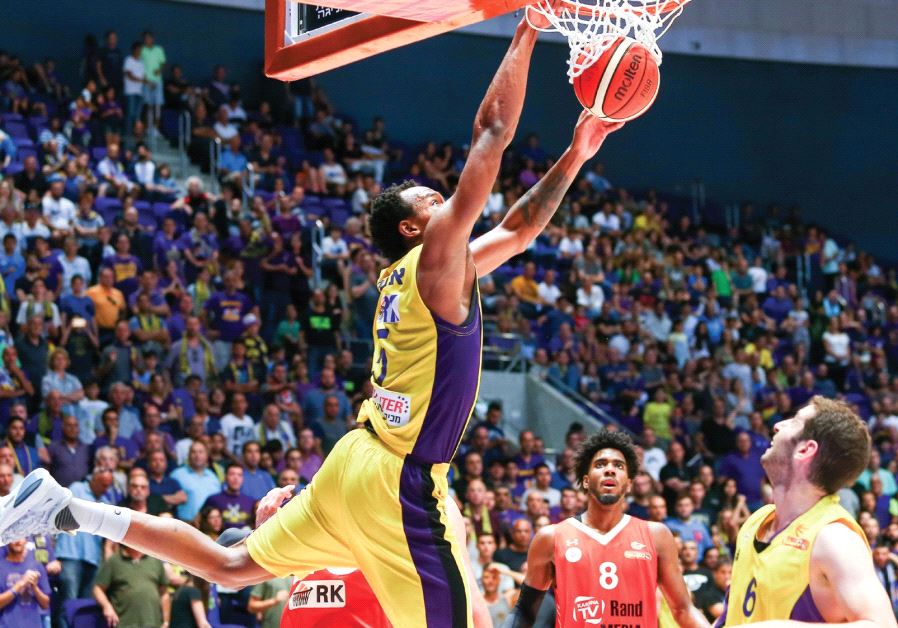 Hapoel Holon forward Darion Atkins (dunking) is hoping to help his team snatch the No. 1 seed in the