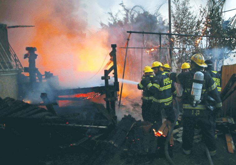 Fire-fighters work to extinguish a fire in Haifa.