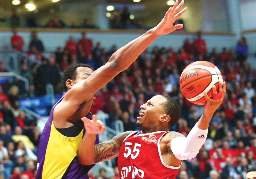 Hapoel Jerusalem guard Curtis Jerrells beats Hapoel Holon’s Darion Atkins to the basket during last 