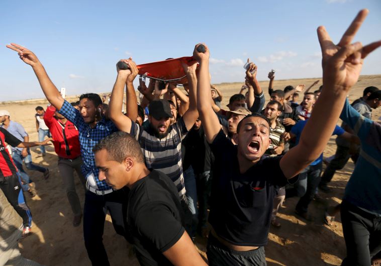 Palestinians evacuate the body of a Palestinian protester