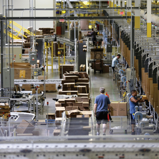 WORKERS SORT products at an Amazon Fulfillment Center in Tracy, California early this month