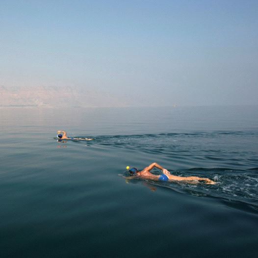 ENVIRONMENTAL ACTIVISTS take part in the Dead Sea Swim Challenge, swimming on Tuesday from the Jorda