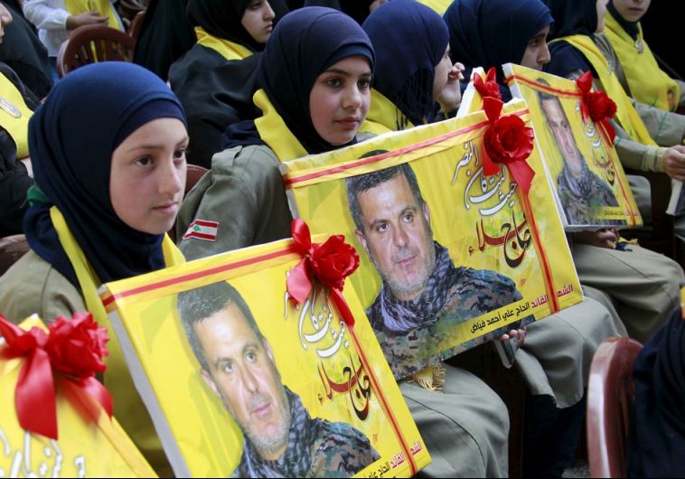 Lebanon's Hezbollah al-Mahdi girl scouts carry pictures of Ali Fayyad